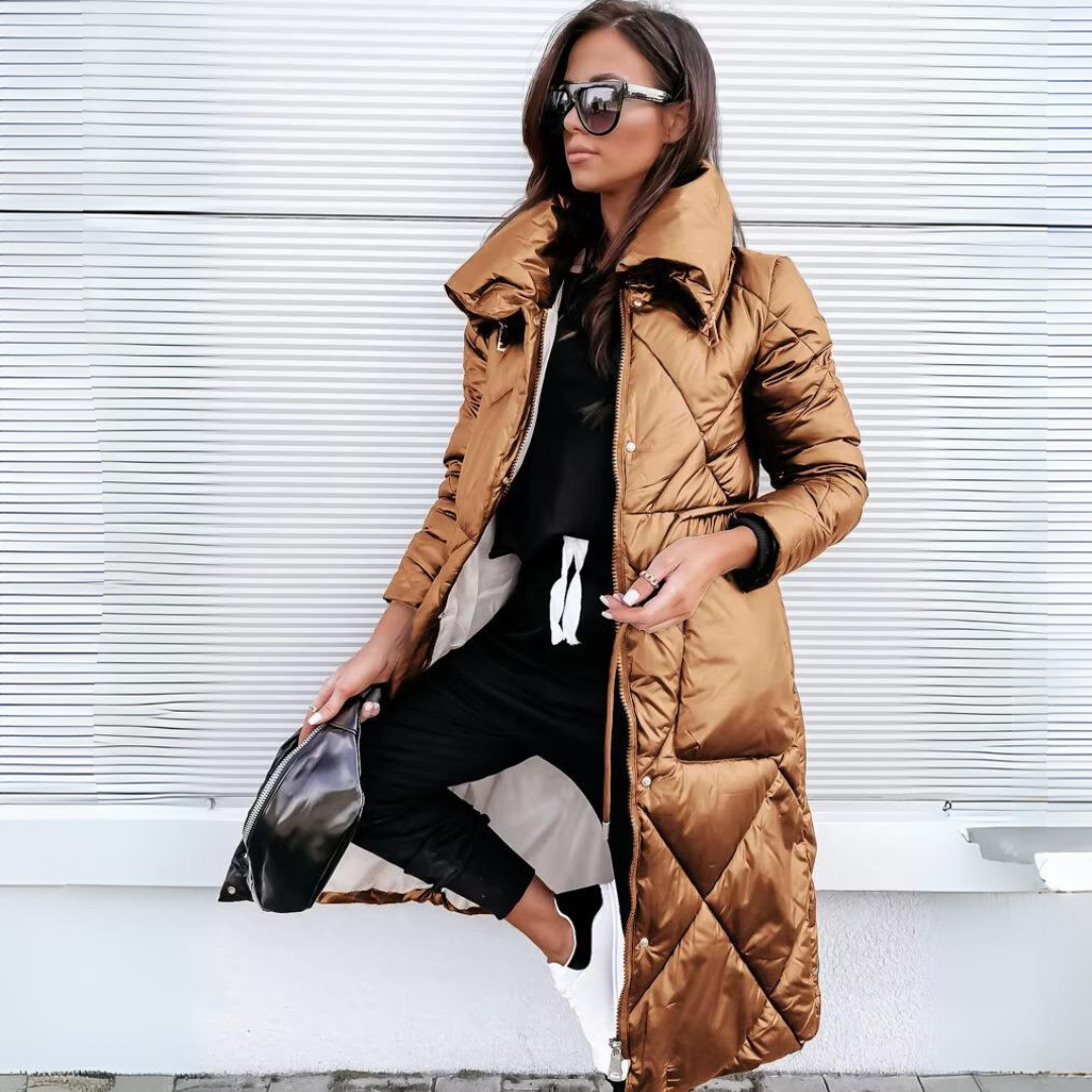 Woman wearing a long brown puffer coat against a white background