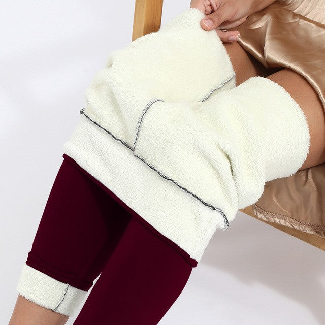 Close-up of a person wearing burgundy pants with white leg warmers on a white background