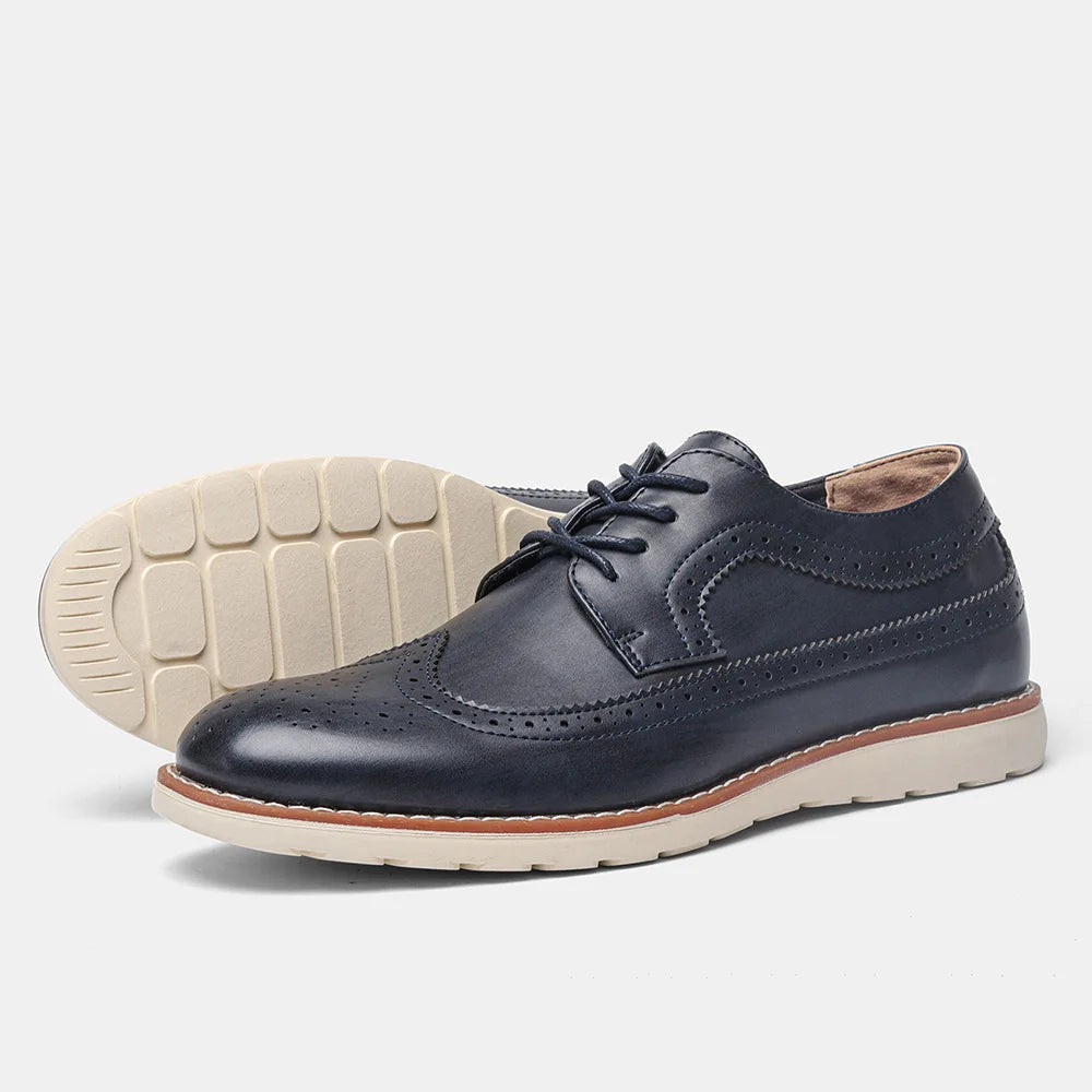 Navy leather shoes with white soles on a light gray background