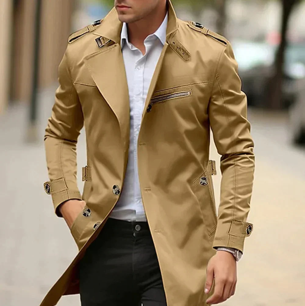 Man wearing a beige trench coat on a blurred street background