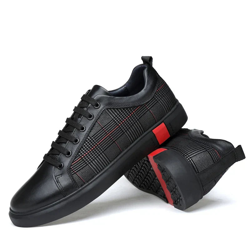 Black sneakers with red accents on a white background