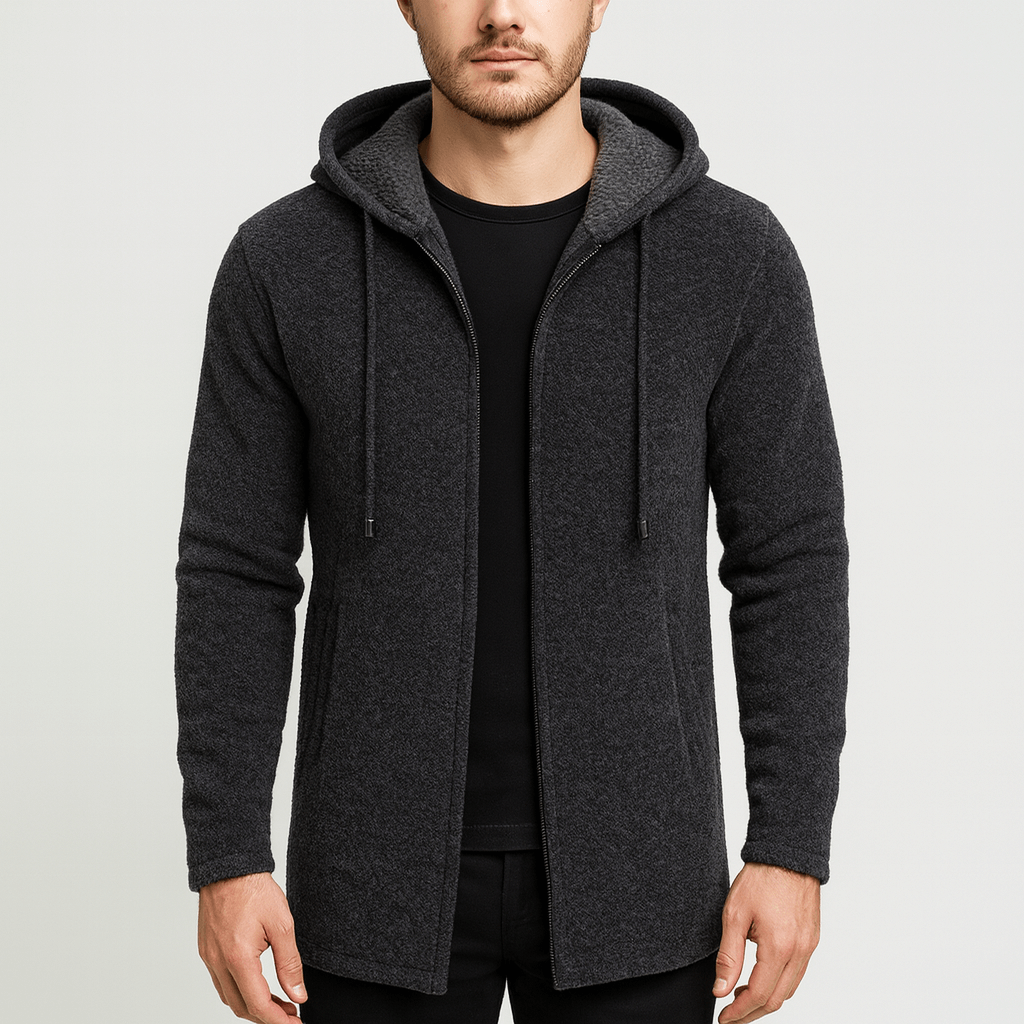 Man wearing a dark gray hooded jacket on a light gray background