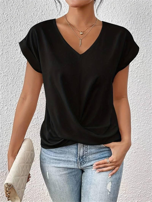 Person wearing a black top and blue jeans against a white background