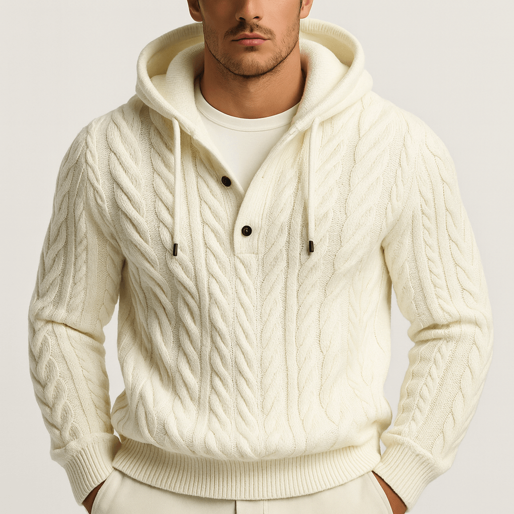 Man wearing a cream-colored cable knit hoodie on a light gray background