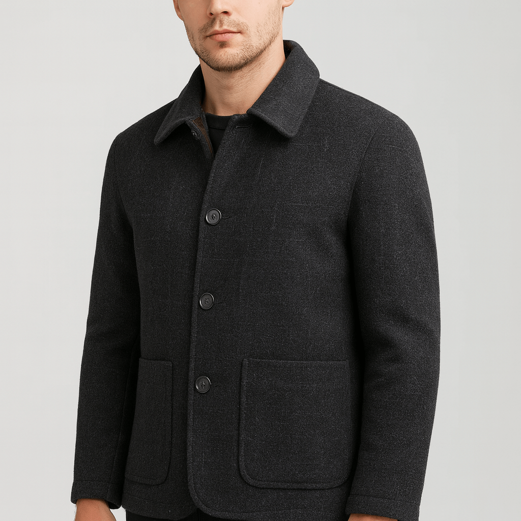 Man wearing a dark gray coat on a light gray background