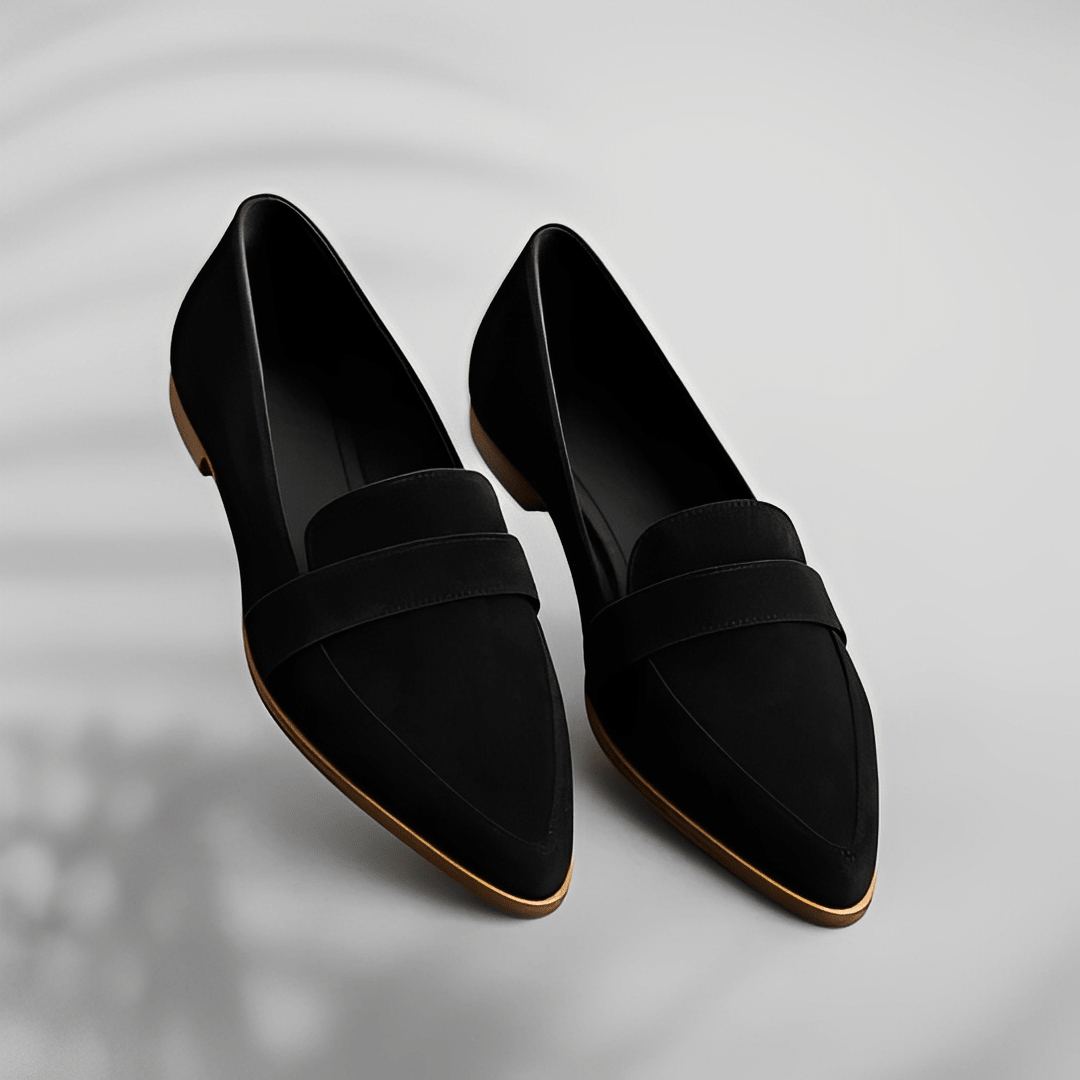 Pair of black loafers on a light gray background