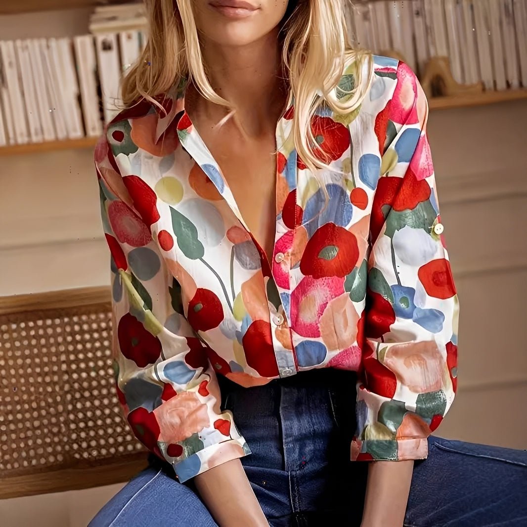 Woman wearing a colorful floral blouse with a blurred background