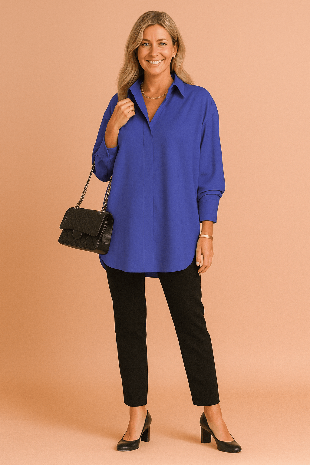 Woman wearing a blue shirt and black pants, holding a black handbag on a beige background