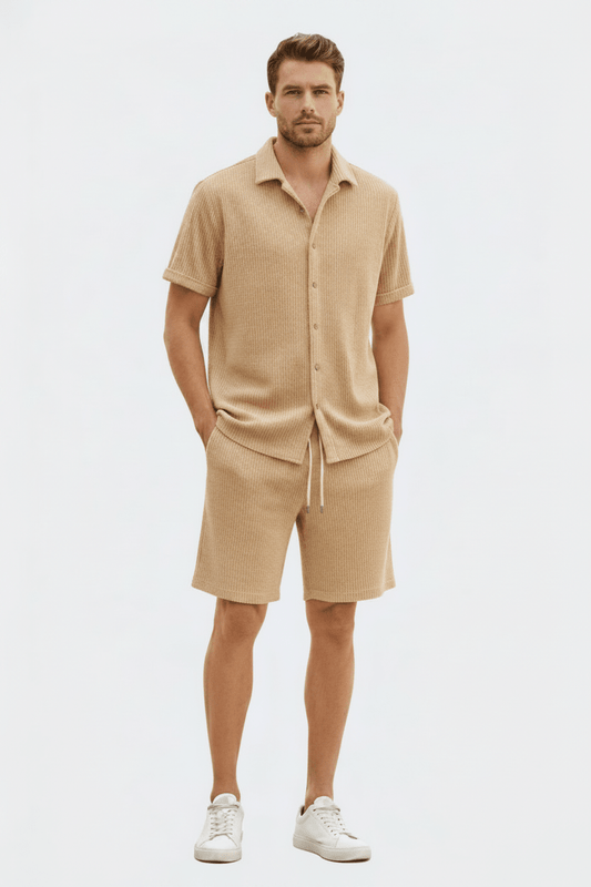 Man wearing a beige outfit with a shirt and shorts on a white background