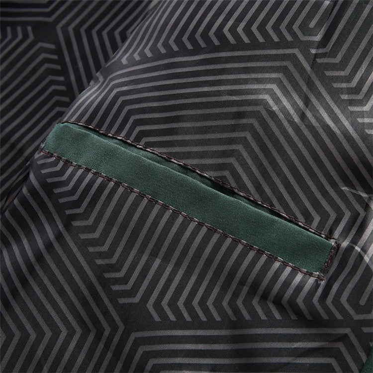 Close-up of a geometric patterned fabric with a green seam.