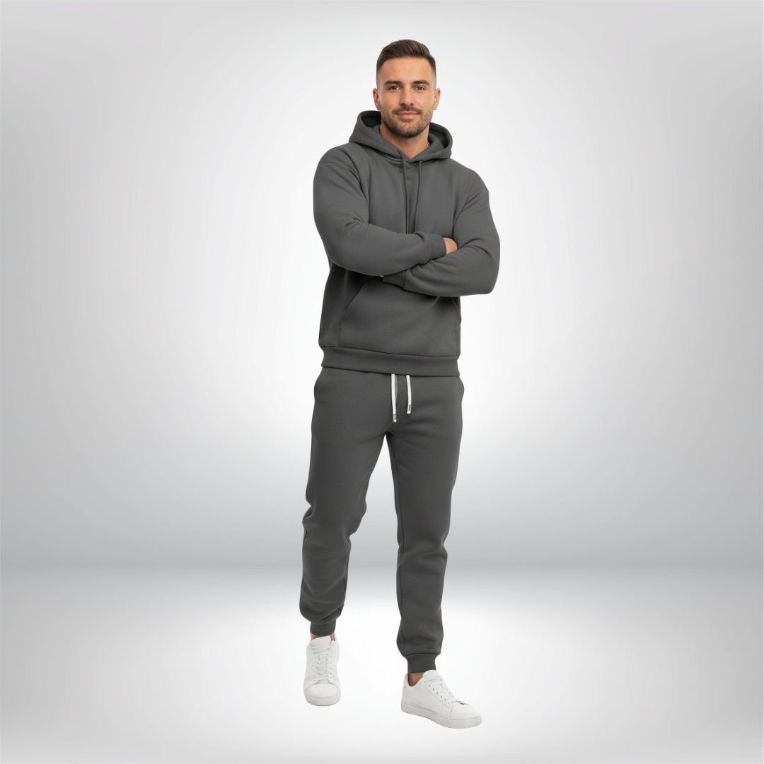 Man wearing a gray tracksuit on a light gray background