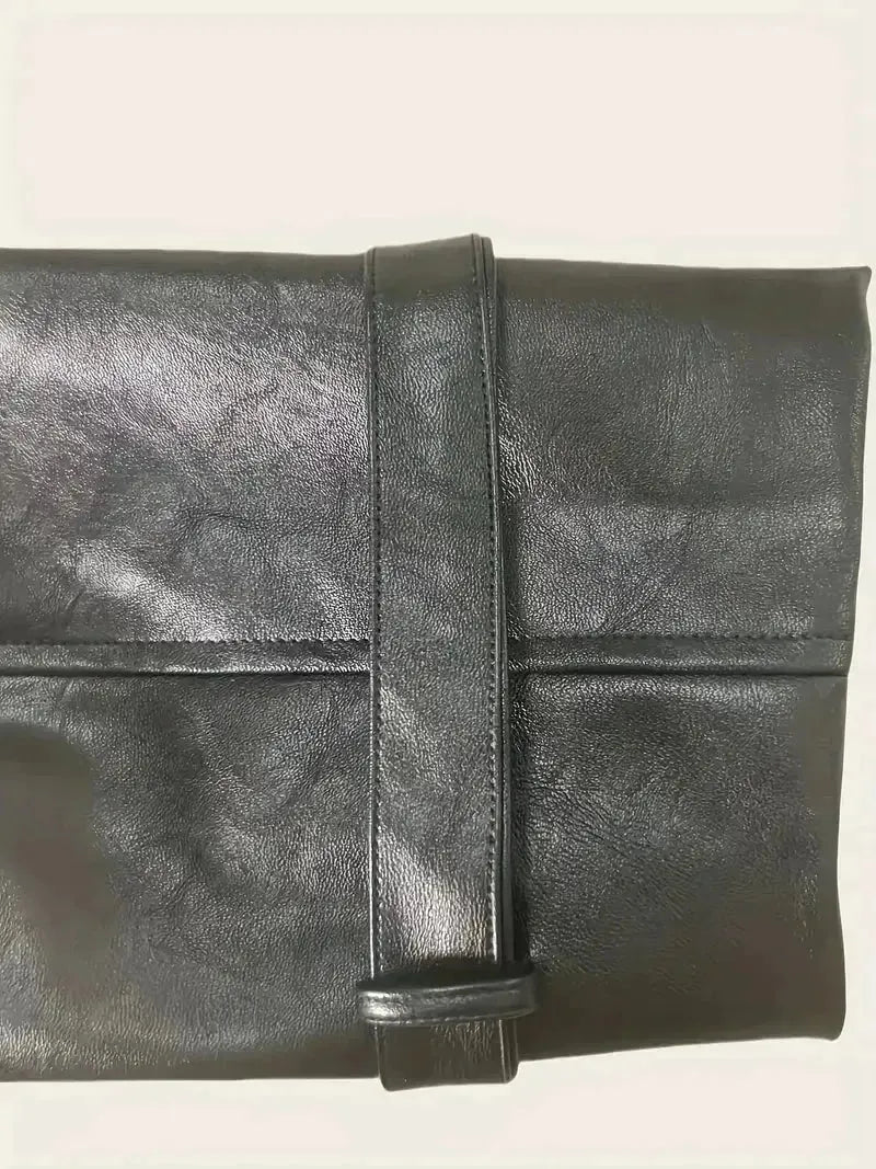 Black leather clutch bag on a light beige background