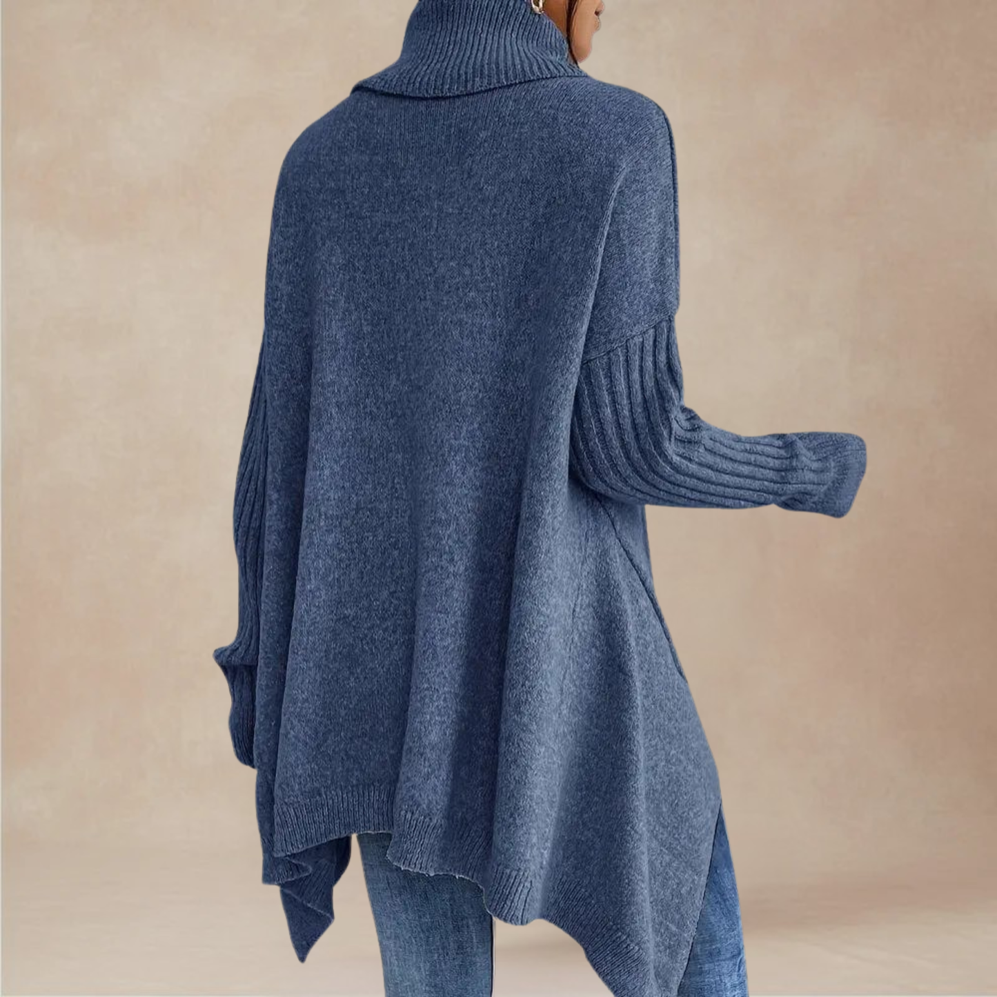 Blue sweater worn by a person on a beige background