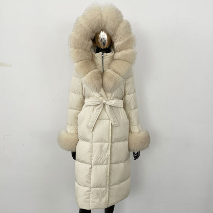 Beige puffer coat with fur hood and belt on a mannequin against a white background