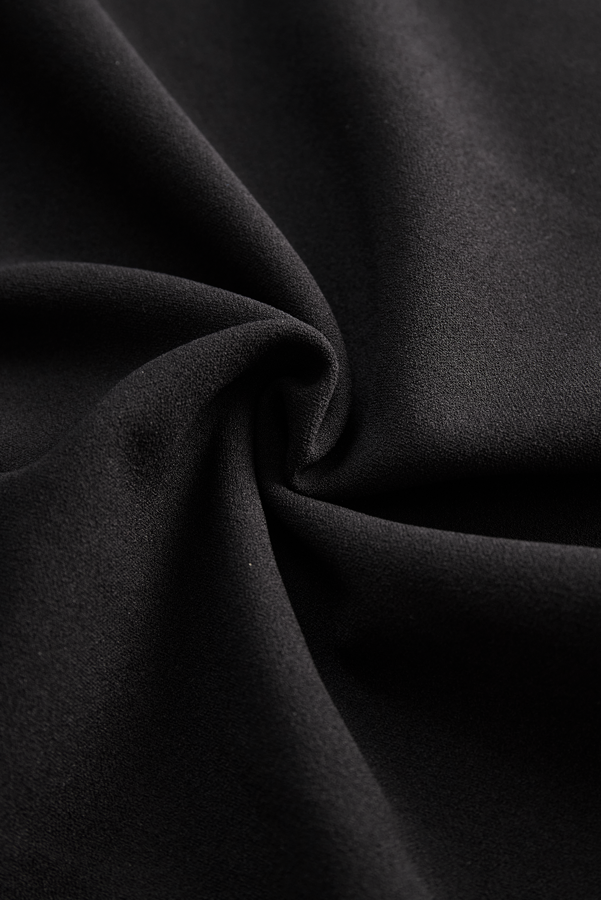 Close-up of black fabric with folds