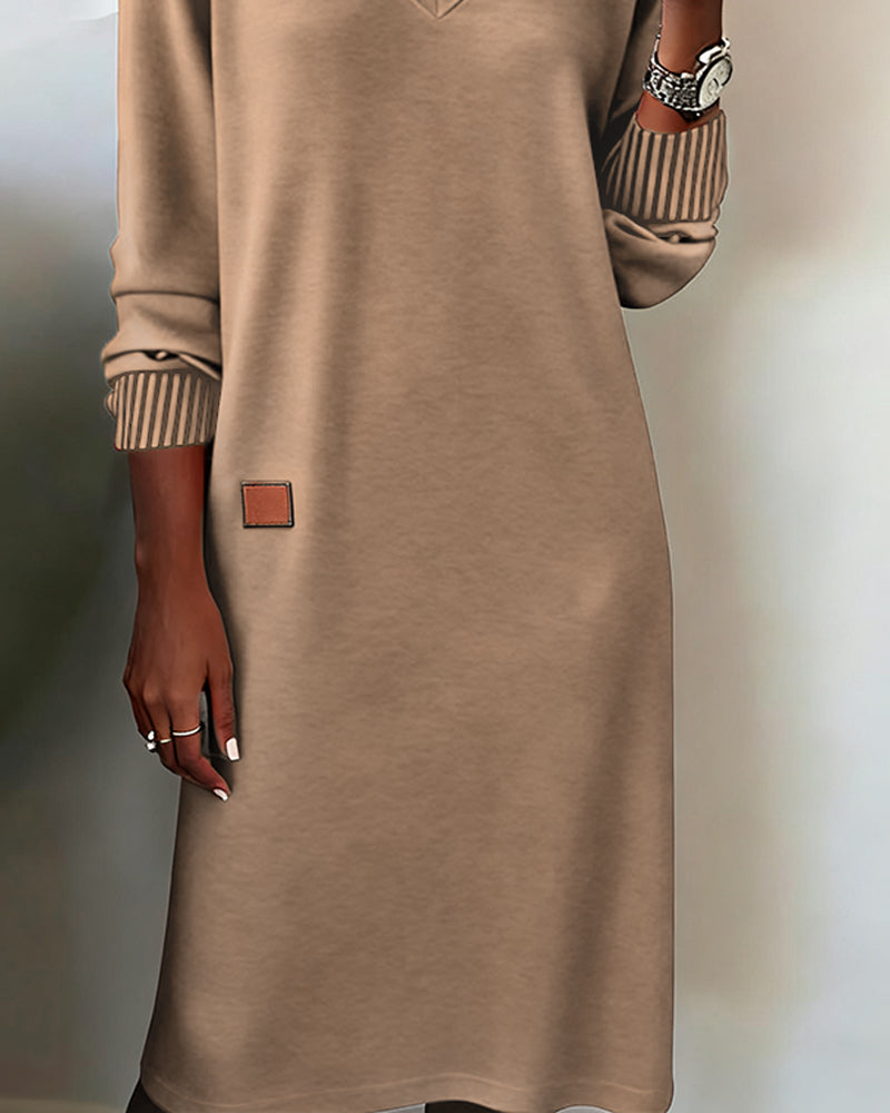 Beige dress with a brown patch on a neutral background