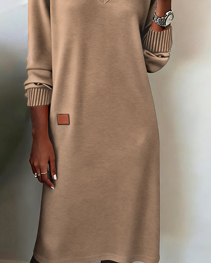 Beige dress with a brown patch on a neutral background