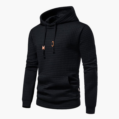 Black textured hoodie with a small orange logo on a white background
