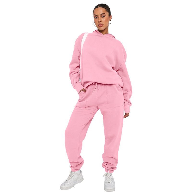 Person wearing a pink tracksuit on a white background