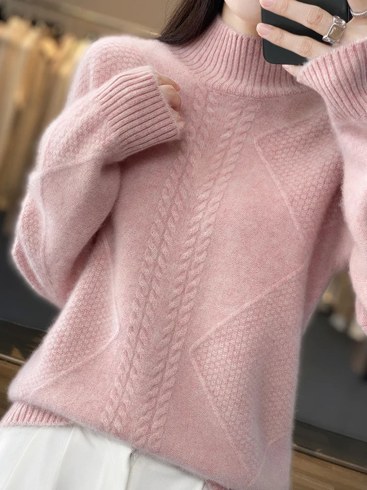 Close-up of a pink knitted sweater with a textured pattern.