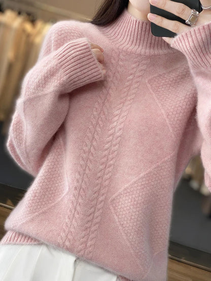 Close-up of a pink knitted sweater with a textured pattern.