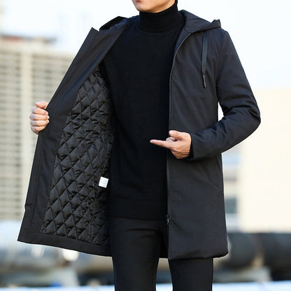 Person wearing a black quilted jacket with a blurred background