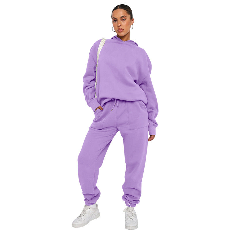Person wearing a purple tracksuit on a white background