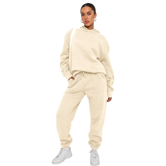 Woman wearing a beige tracksuit on a white background