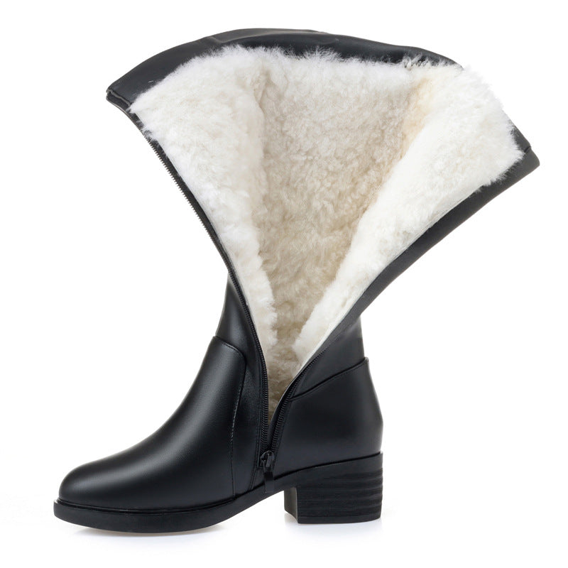 Black boot with white fur lining on a white background