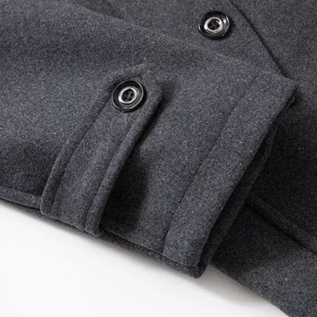 Close-up of a gray coat with buttons on a white background