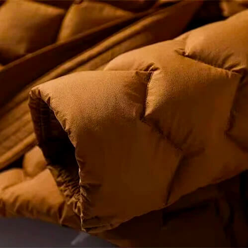 Close-up of a brown puffer jacket with visible stitching details.