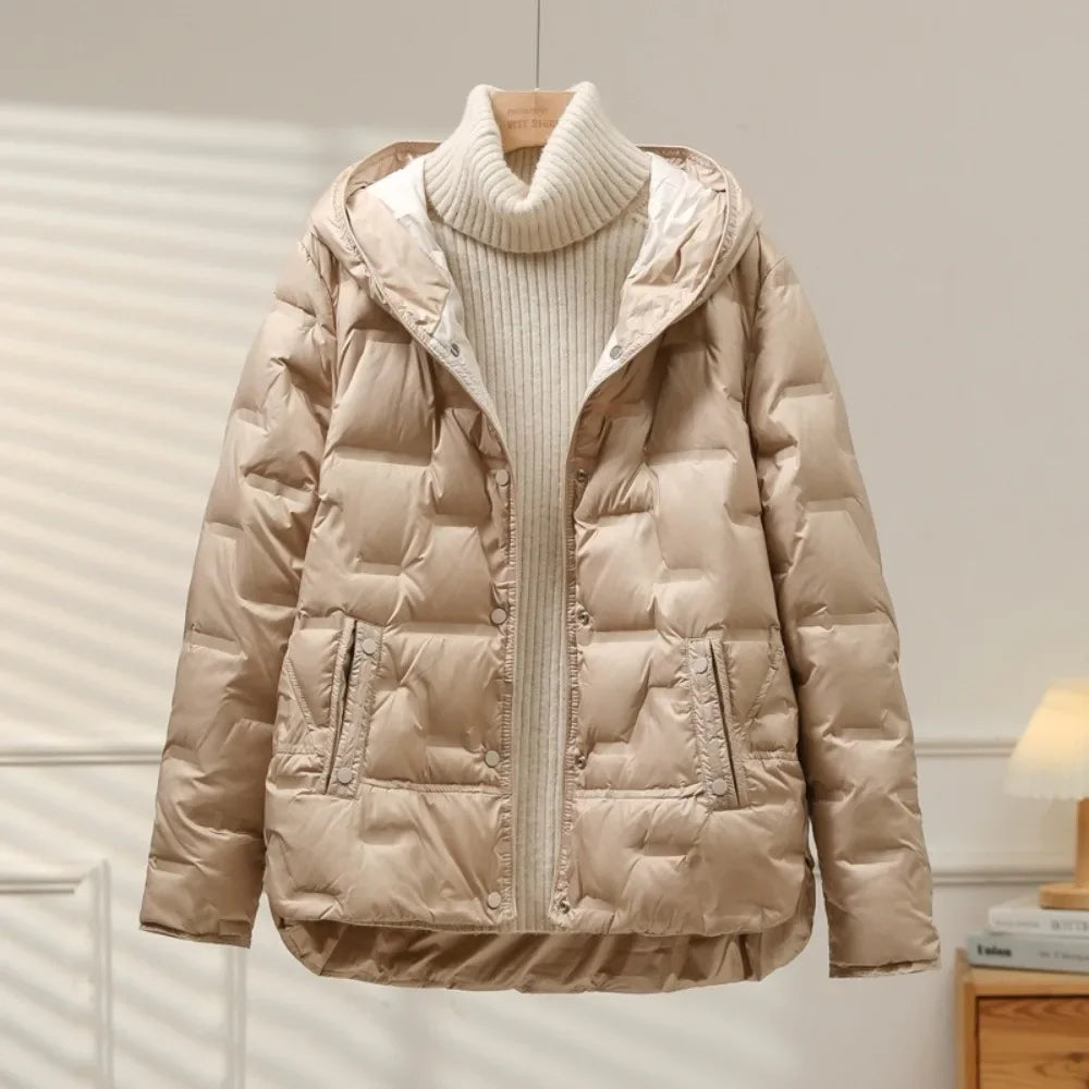 Beige puffer jacket on a hanger against a neutral background