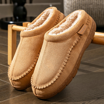 Pair of tan slippers on a wooden chair with a blurred background