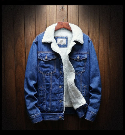 Blue denim jacket with white fur lining on a wooden hanger against a wooden background