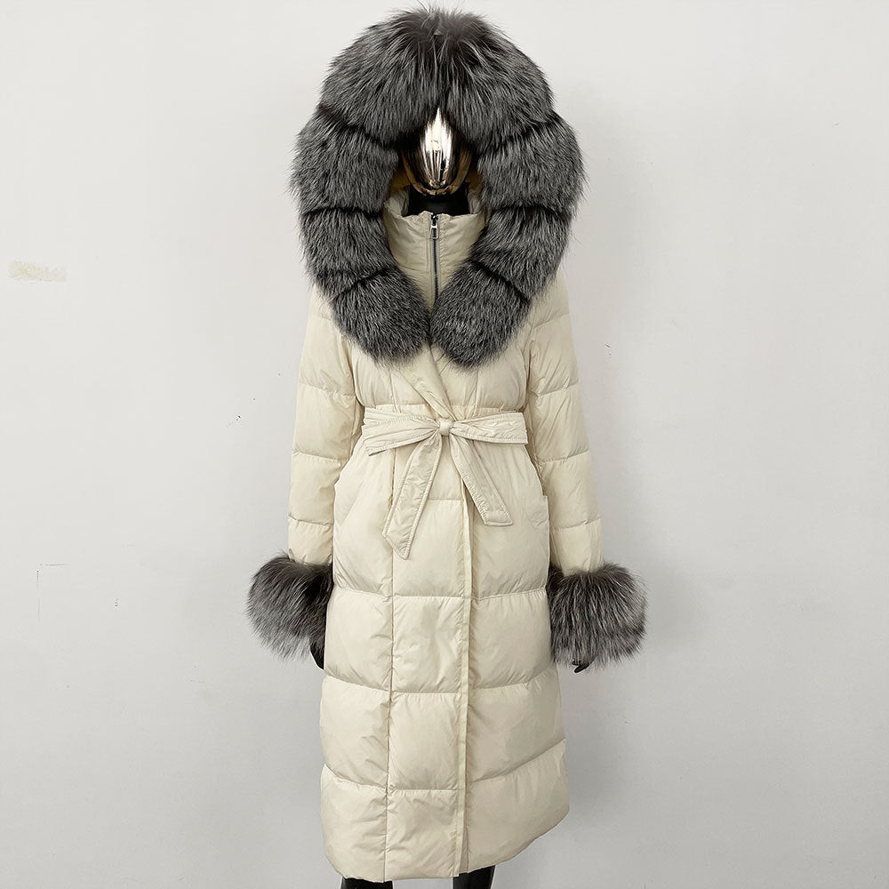 Long beige coat with a large fur hood and cuffs on a white background