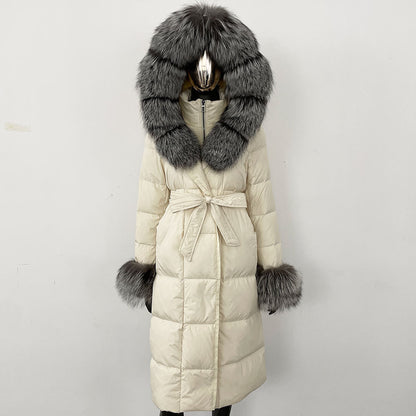 Long beige coat with a large fur hood and cuffs on a white background
