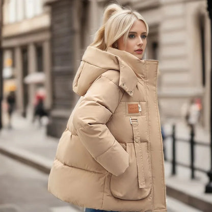 Woman wearing a beige puffer jacket on a city street