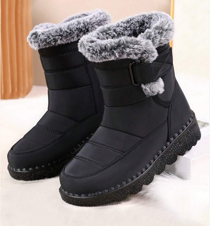 Black snow boots with gray fur lining on a light background