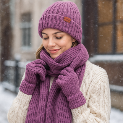 Woman wearing a purple knit hat and scarf in a snowy outdoor setting