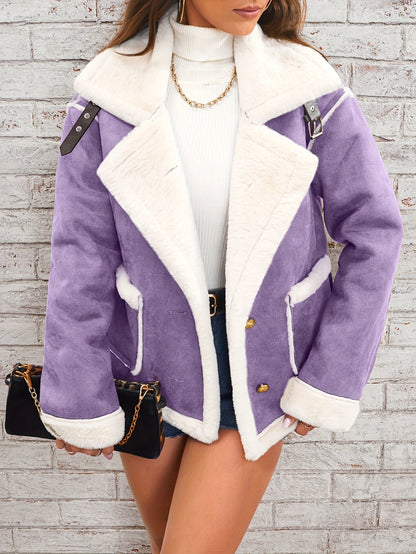 Purple coat with white fur lining worn by a person against a light gray brick wall.