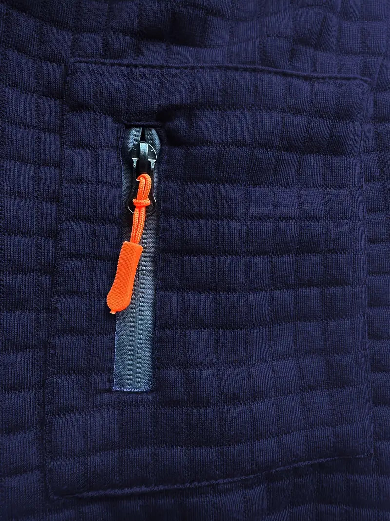 Close-up of a navy blue quilted jacket with an orange zipper