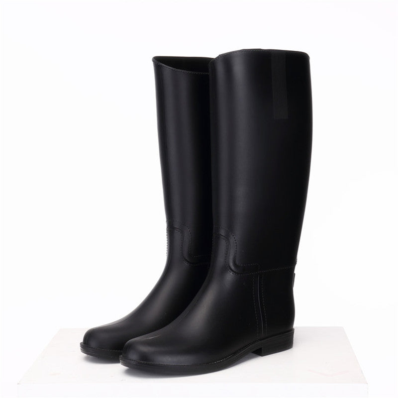 Pair of black rubber boots on a white background