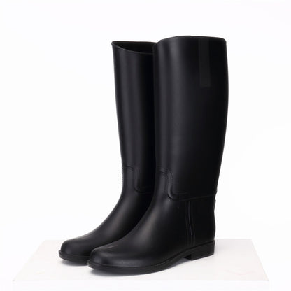 Pair of black rubber boots on a white background