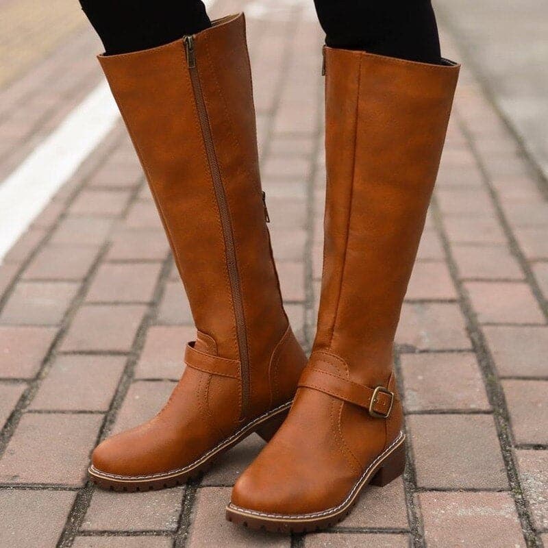 Brown knee-high boots on a paved surface
