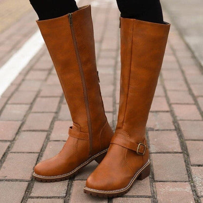 Brown knee-high boots on a paved surface