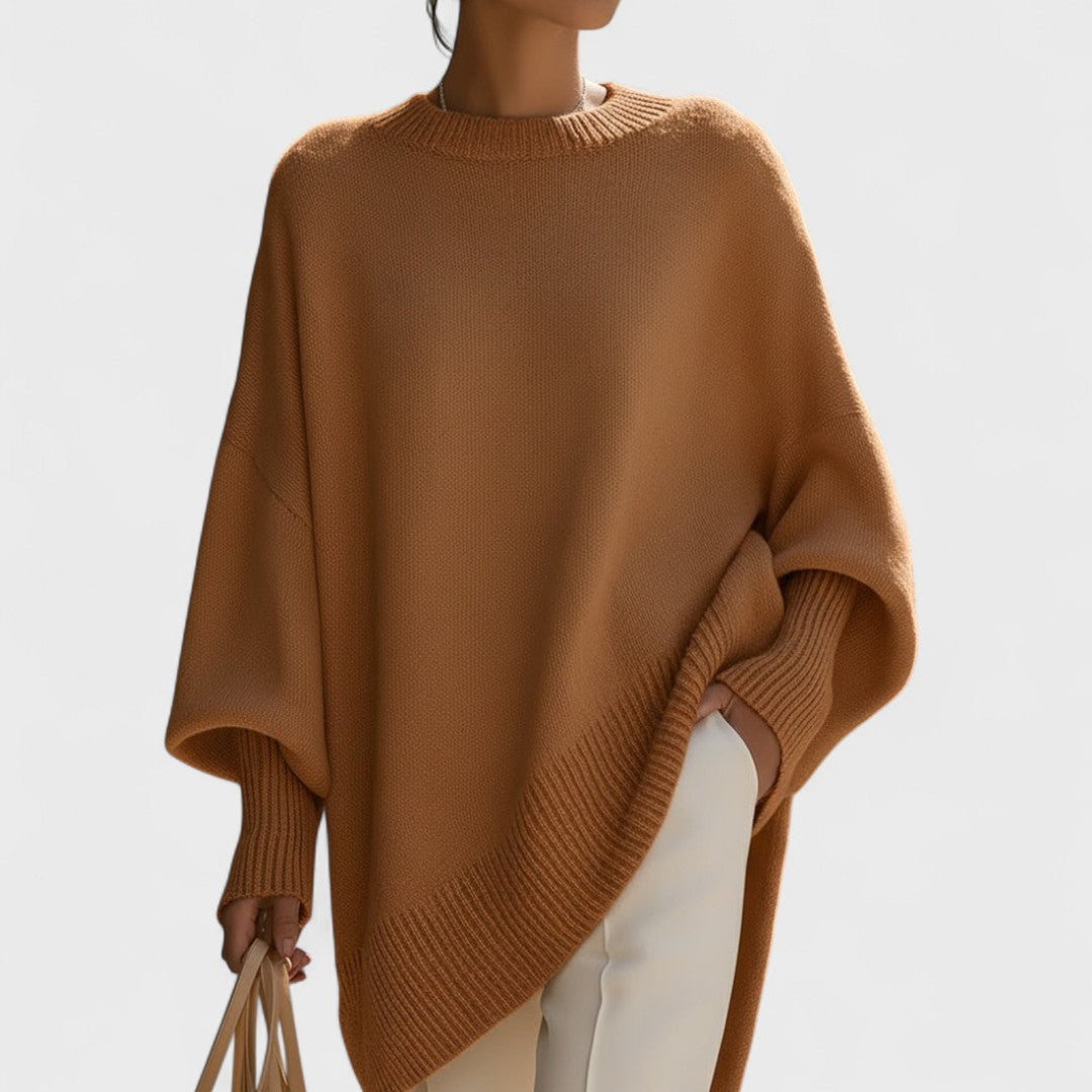 Brown poncho worn by a person on a plain background
