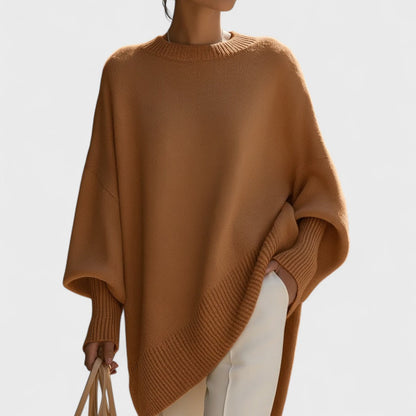 Brown poncho worn by a person on a plain background