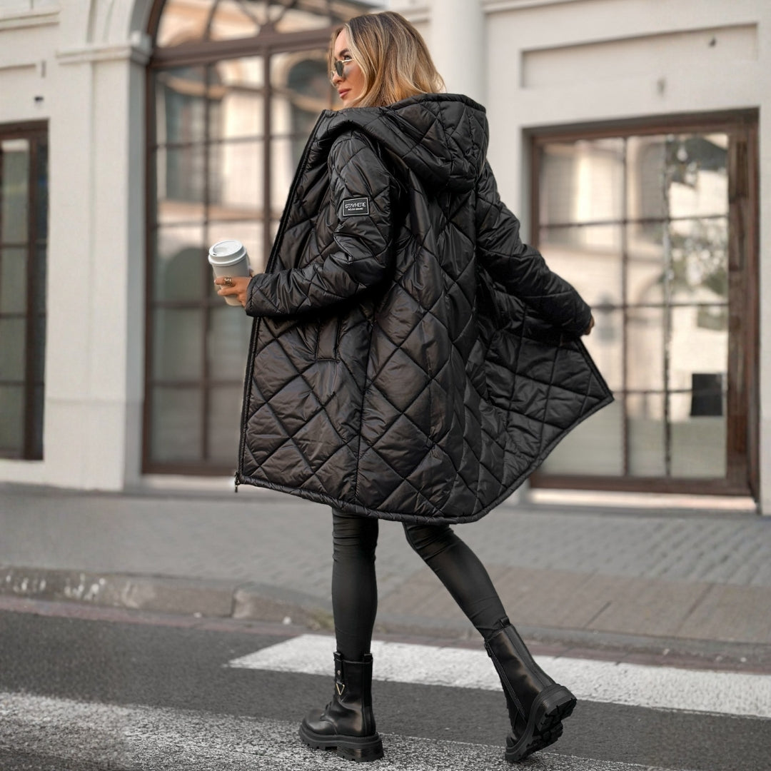 Woman wearing a black quilted jacket on a city street