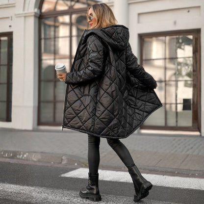 Woman wearing a black quilted jacket on a city street
