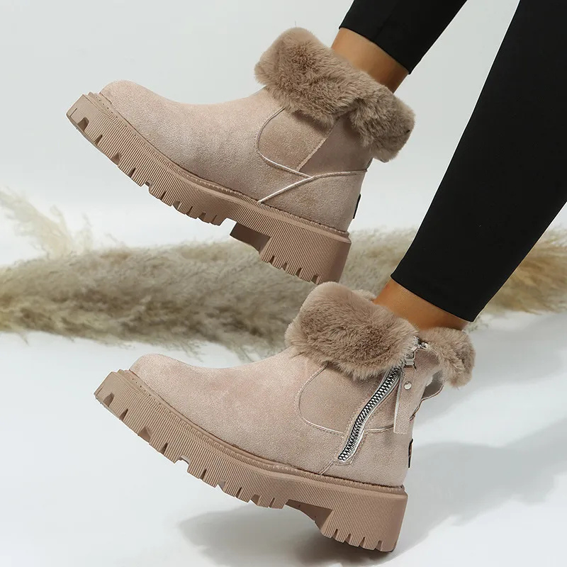 Beige winter boots with fur trim worn by a person on a light background